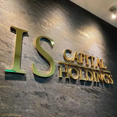 Custom 3D metal business logo sign with gold letters on a textured dark wall